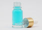 Botella de cristal cosmética clara de la forma redonda del color 15ml con el dropper del aluminio del oro